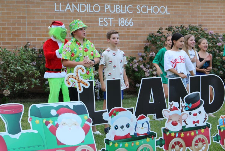 Students dressed in Christmas mufti singing.