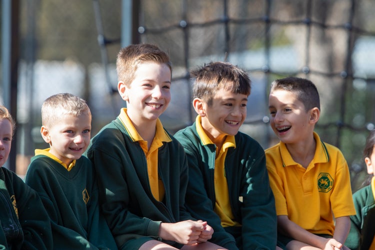 Students sitting in the playground.