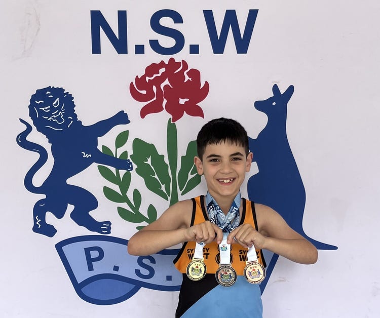 Student athlete posing with three medicals, gold, silver and bronze.