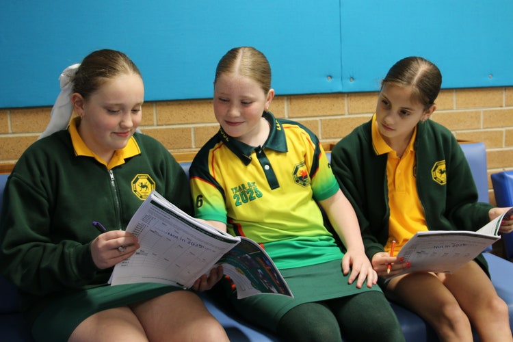 Students sitting together to complete an activity.